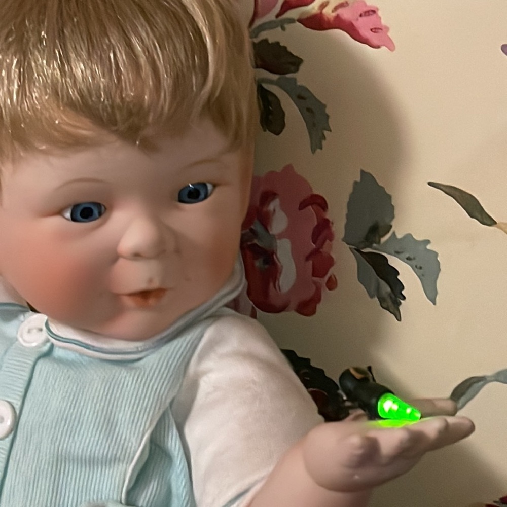 AstonDrake porcelain doll with lighting bug, batteries included, no certificate
